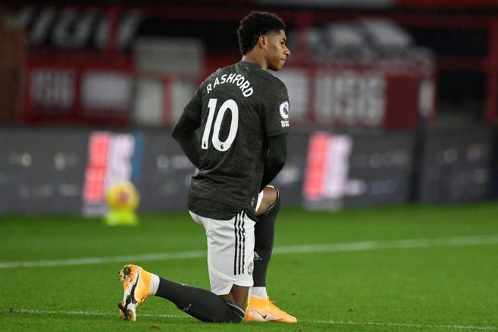 Manchester United forward Marcus Rashford takes a knee