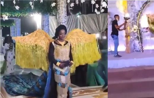African print-wearing bride's angelic entrance into wedding venue