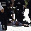 French riot police attend to England fan Andrew Bache as he lies injured after the violence in Marseille before a Euro 2016 match