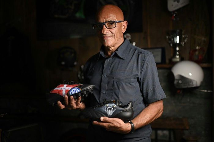 Italian artist Salvatore Cosentino poses with a pair of boots he designed as a tribute to Christian Eriksen