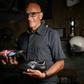 Italian artist Salvatore Cosentino poses with a pair of boots he designed as a tribute to Christian Eriksen