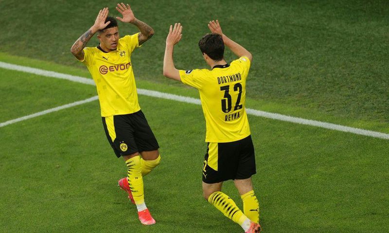 US midfielder Giovanni Reyna (R) and Jadon Sancho celebrate Dortmund's German Cup semi-final rout of Kiel