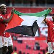 Manchester United manager Ole Gunnar Solskjaer defended French midfielder Paul Pogba (L) and Ivorian midfielder Amad Diallo (R) holding a Palestinian flag saying they have a right to a different view