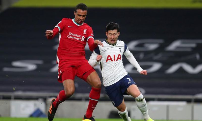 Liverpool defender Joel Matip (L) tackles Tottenham's Son Heung-min
