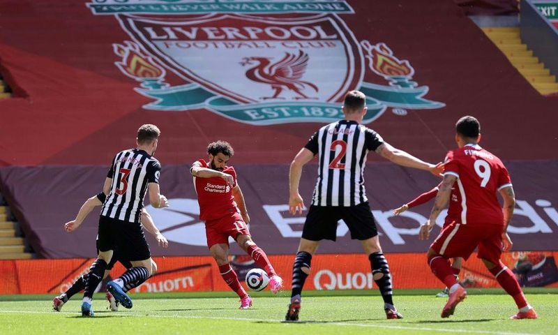 Mohamed Salah (2L) puts Liverpool ahead in a 1-1 draw against Newcastle United at Anfield