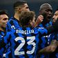 Inter Milan midfielder Arturo Vidal (R) and Nicolo Barella (C) celebrate after scoring against Juventus.