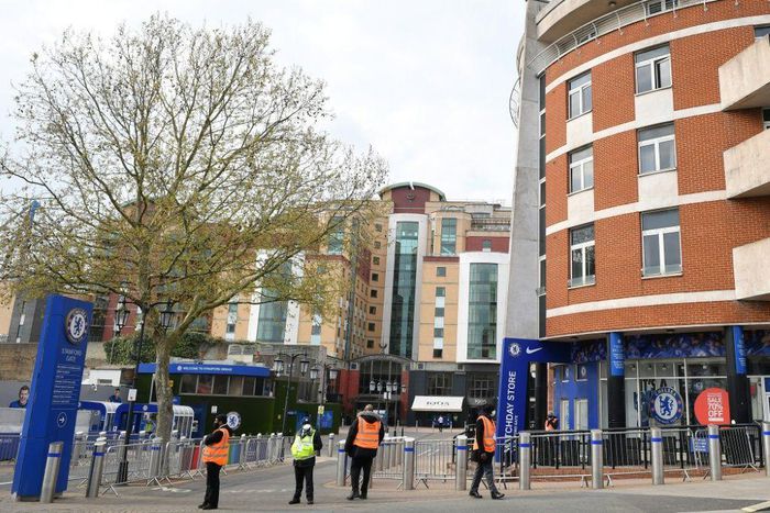Security guards stand with stewards outside Chelsea's Stamford Bridge stadium