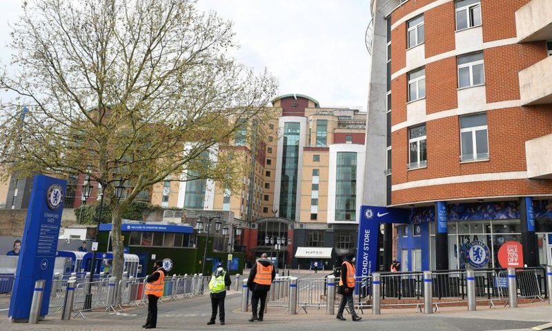 Security guards stand with stewards outside Chelsea's Stamford Bridge stadium