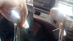 Trotro driver uses showerhead as a gear stick knob for the rickety vehicle
