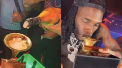 Burna Boy shows up in Nigerian club with Grammy plaque and drinks from it (WATCH)