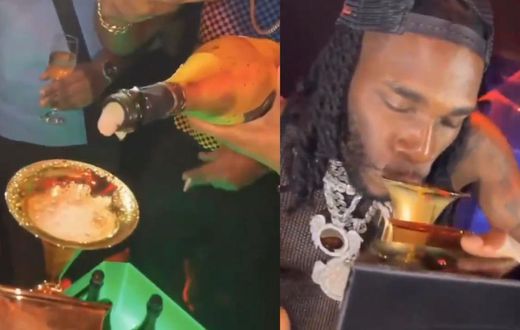 Burna Boy shows up in Nigerian club with Grammy plaque and drinks from it (WATCH)