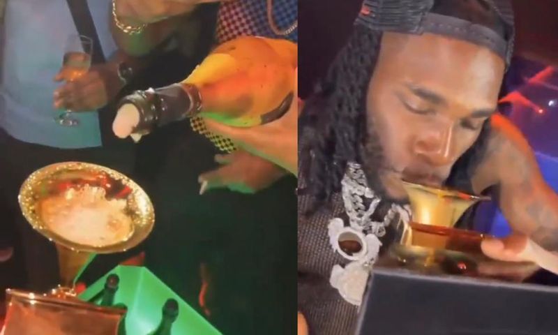 Burna Boy shows up in Nigerian club with Grammy plaque and drinks from it (WATCH)