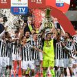 Juventus's veteran goalkeeper Gianluigi Buffon holds the Coppa Italia trophy.