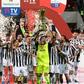 Juventus's veteran goalkeeper Gianluigi Buffon holds the Coppa Italia trophy.