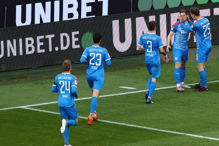 Man of the moment: Holstein Kiel defender Simon Lorenz (second right) celebrates his goal