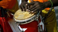 The dancing is accompanied by the five-step clave beat from African drums