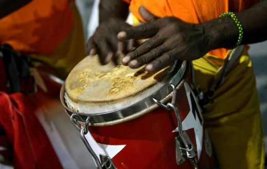 The dancing is accompanied by the five-step clave beat from African drums