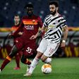 Roma's Gambian defender Ebrima Darboe (L) fights for the ball with Manchester United's Bruno Fernandes.