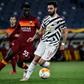 Roma's Gambian defender Ebrima Darboe (L) fights for the ball with Manchester United's Bruno Fernandes.