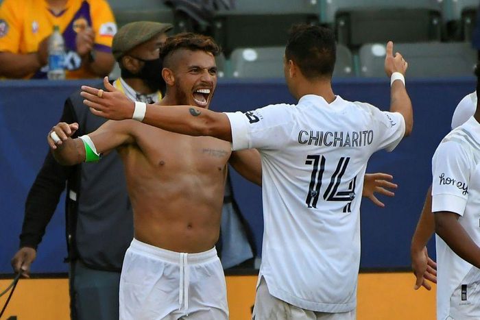 Shirtless  Jonathan dos Santos is congratulated by Los Angeles Galaxy teammate Javier Hernandez after scoring in the Galaxy's 2-1 Major League Soccer victory over Los Angeles FC
