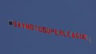 A plane flies above  Elland Road in Leeds before the Premier League game against Liverpool protesting against the planned Super League