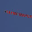 A plane flies above  Elland Road in Leeds before the Premier League game against Liverpool protesting against the planned Super League