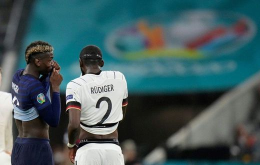 France midfielder Paul Pogba (left) speaks with Germany defender Antonio Ruediger during their Euro 2020 match in Munich