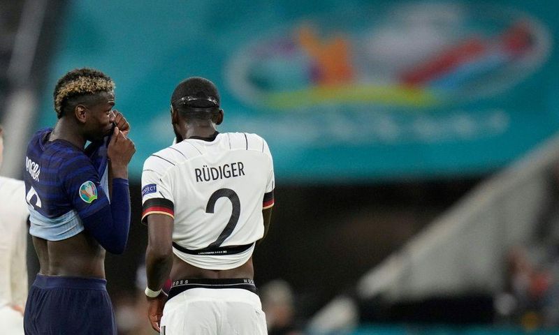 France midfielder Paul Pogba (left) speaks with Germany defender Antonio Ruediger during their Euro 2020 match in Munich