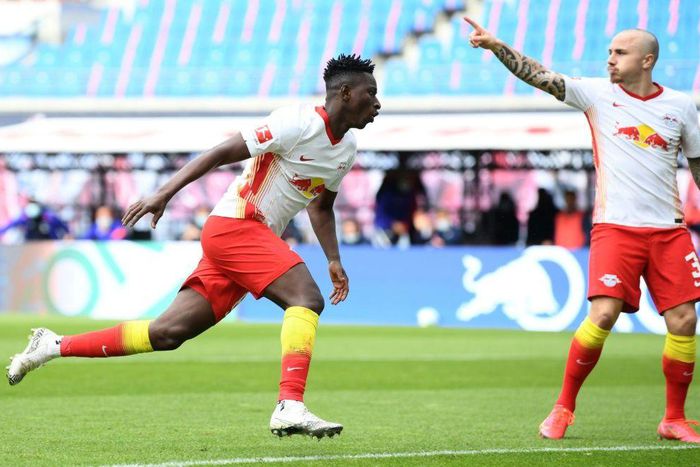 Amadou Haidara (L) celebrates scoring RB Leipzig's opening goal at home to Stuttgart on Sunday