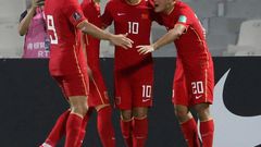 Chinese players celebrate beating  Syria at the Sharjah Football Stadium to secure their place in the final qualifying round for Qatar 2022