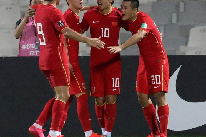 Chinese players celebrate beating  Syria at the Sharjah Football Stadium to secure their place in the final qualifying round for Qatar 2022