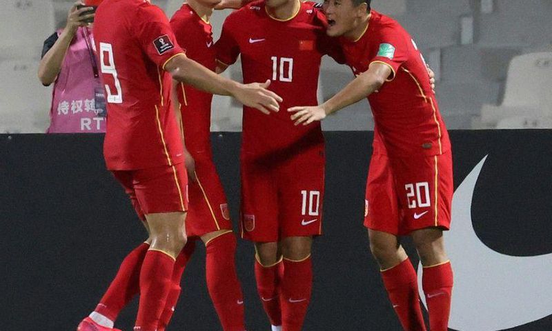 Chinese players celebrate beating  Syria at the Sharjah Football Stadium to secure their place in the final qualifying round for Qatar 2022