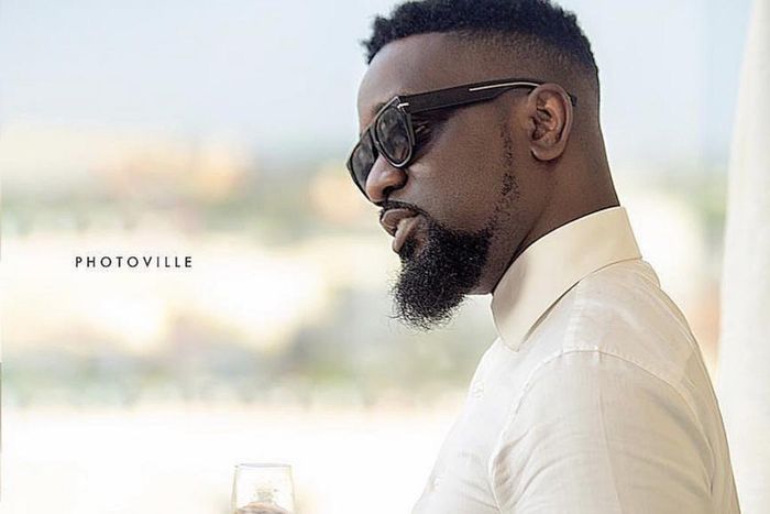 Sarkodie holding wine glass