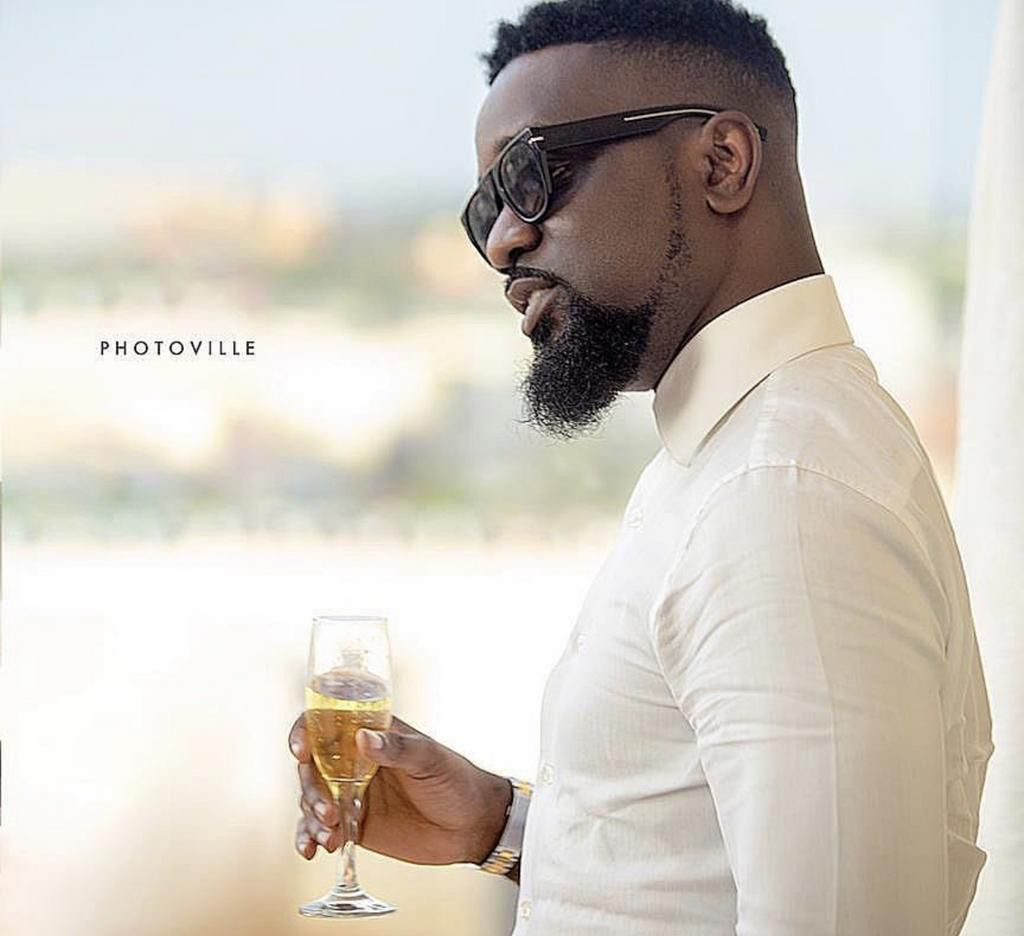 Sarkodie holding wine glass