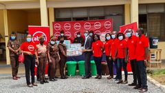 Absa Bank employees presenting the items to officials of the Senior Correctional Centre