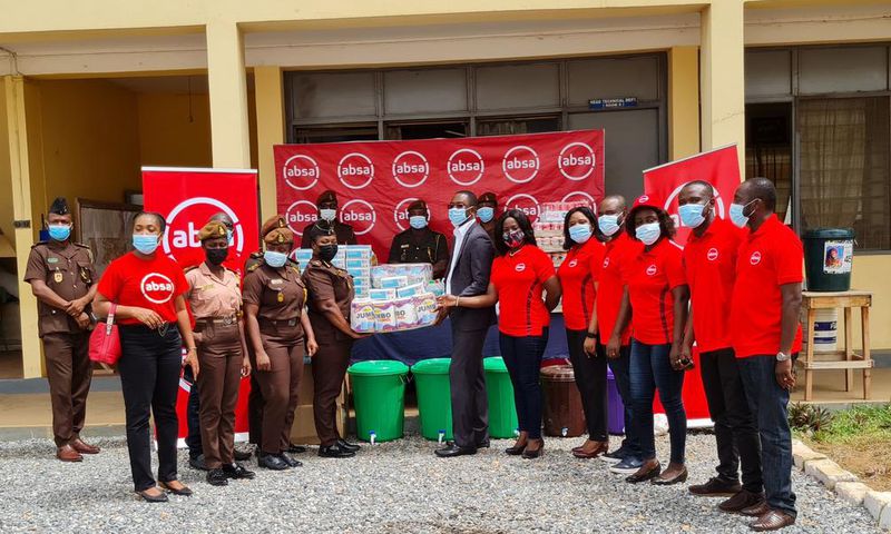 Absa Bank employees presenting the items to officials of the Senior Correctional Centre