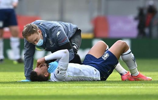 Injured - Aston Villa midfielder Trezeguet receives medical attention during a Premier League match against Liverpool at Anfield on Saturday