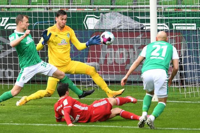 Bayern Munich striker Robert Lewandowski (C, bottom) scored and hit the woodwork three times at Werder Bremen on Saturday