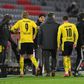 Erling Braut Haaland (L) leaves the field with an ankle injury after scoring twice in Dortmund's defeat at Bayern Munich