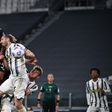 AC Milan's English defender Fikayo Tomori (Top L) headed in a third goal against Juventus in Turin.