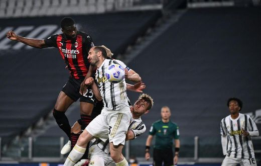 AC Milan's English defender Fikayo Tomori (Top L) headed in a third goal against Juventus in Turin.
