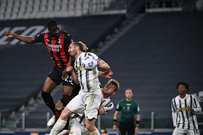 AC Milan's English defender Fikayo Tomori (Top L) headed in a third goal against Juventus in Turin.