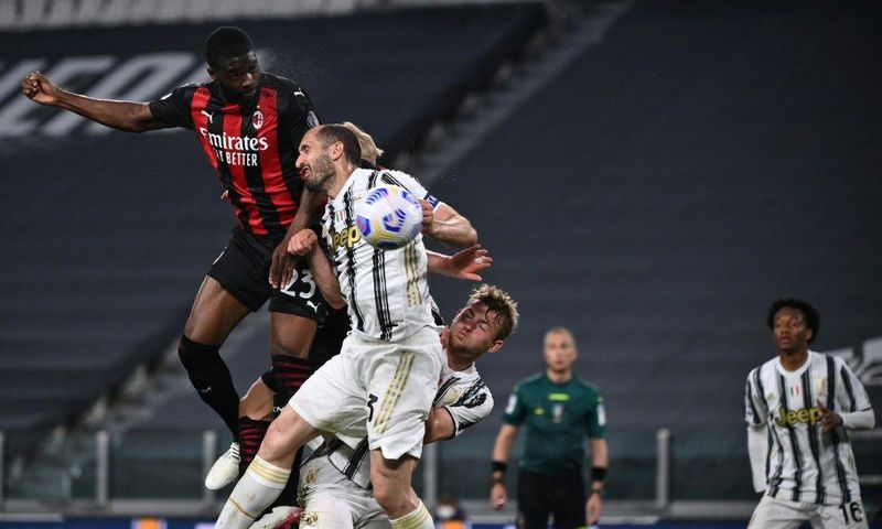 AC Milan's English defender Fikayo Tomori (Top L) headed in a third goal against Juventus in Turin.