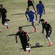 Palestinian footballers compete in the final of a local championship for amputees between Al-Jazeera (black kit) and Al-Abtal (blue kit) organised by the International Committee of the Red Cross and the Palestinian Football Association in Gaza City