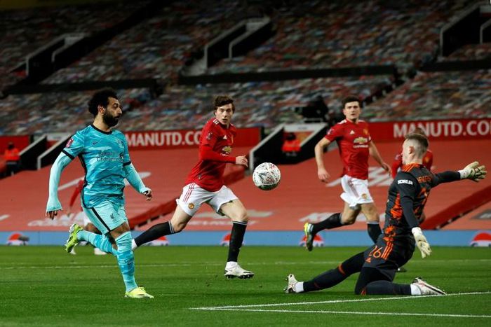 Mohamed Salah (L) scores the first of two goals for Liverpool in a FA Cup loss at Manchester United