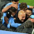 Pep Guardiola celebrates with his Manchester City players