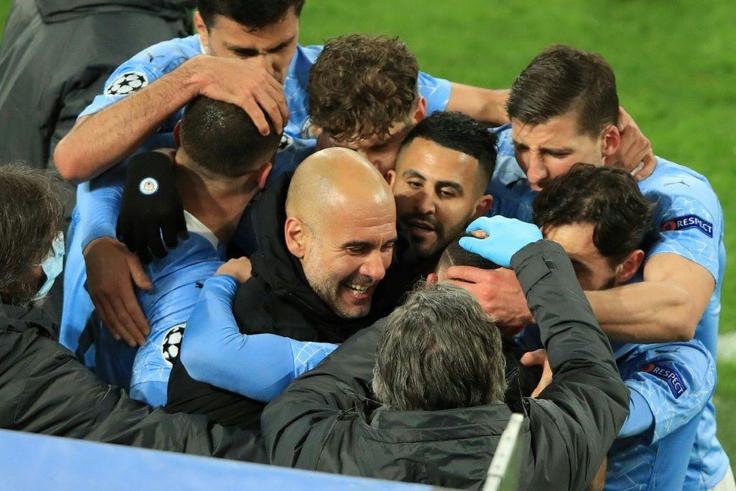 Pep Guardiola celebrates with his Manchester City players