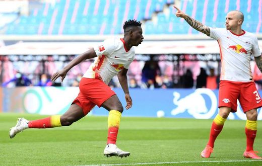 Amadou Haidara (L) celebrates scoring RB Leipzig's opening goal at home to Stuttgart on Sunday