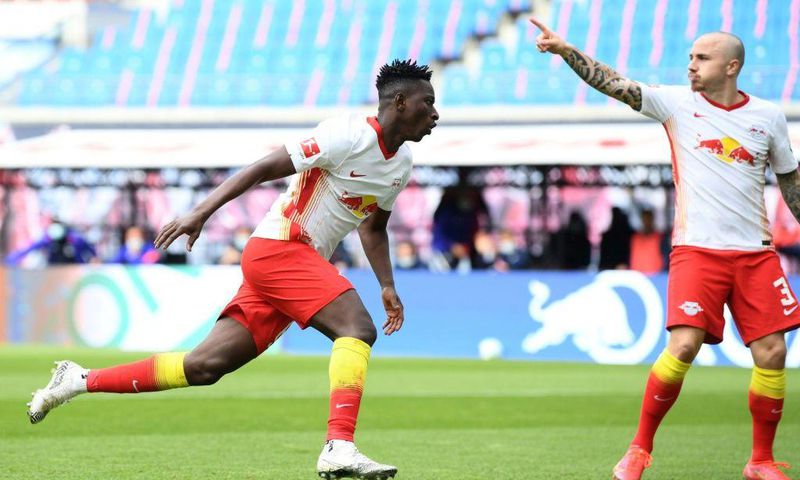 Amadou Haidara (L) celebrates scoring RB Leipzig's opening goal at home to Stuttgart on Sunday
