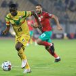 Moussa Kone (L) of Mali is pursued by Abdelmounaim Boutouil of Morocco during the African Nations Championship final in Yaounde Sunday.